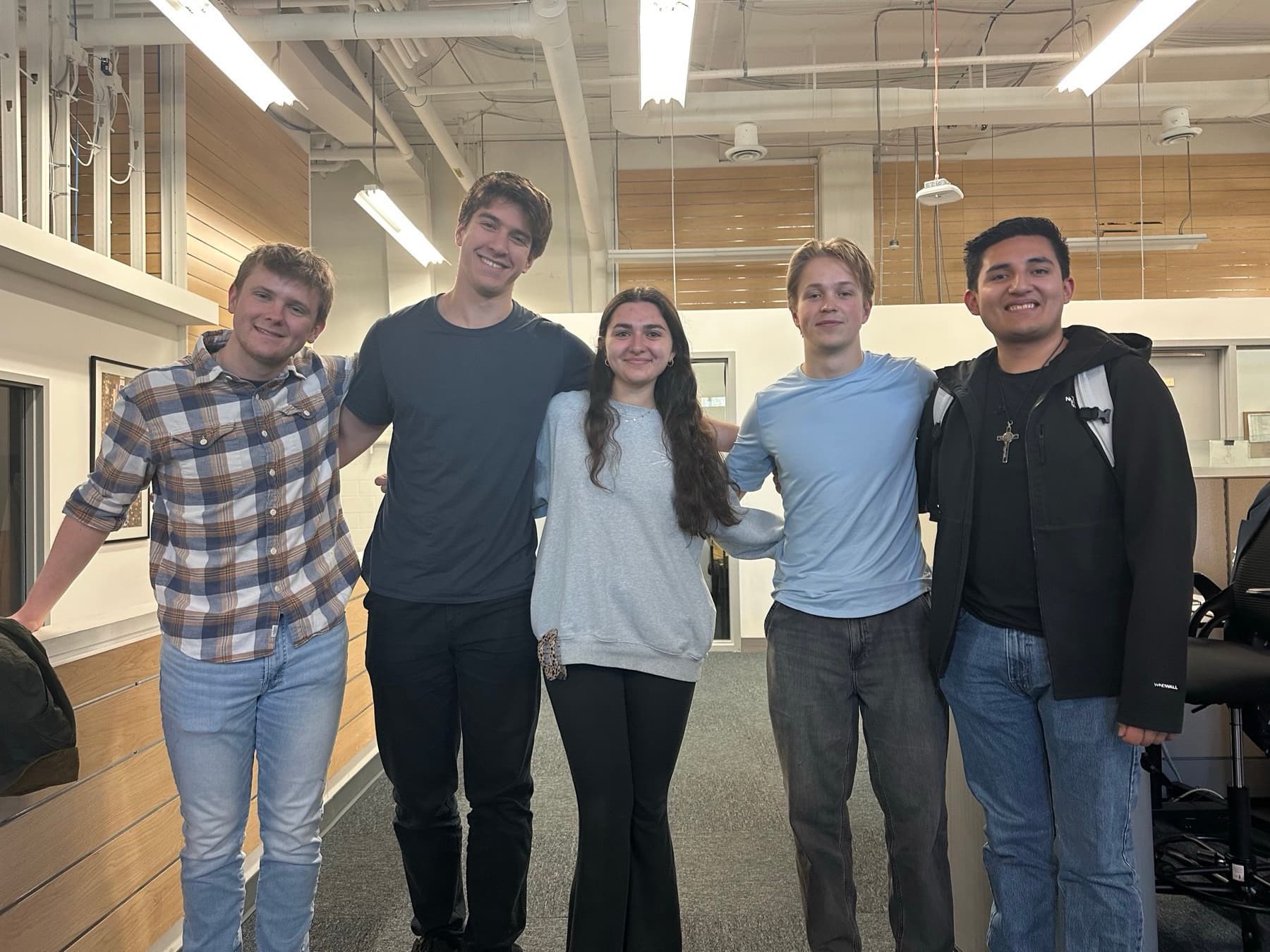 Five HoyaTaxa volunteers arm in arm at the Minnesota Ave tax site